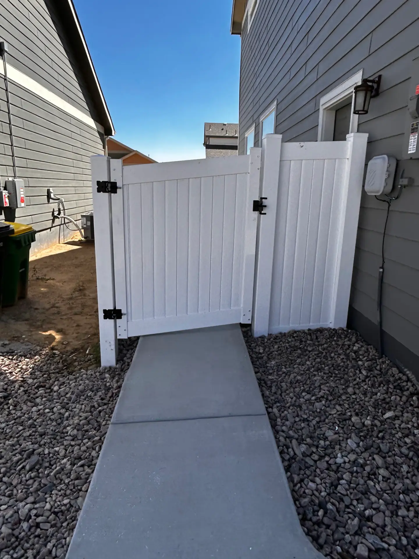 White vinyl privacy walk gate fitted between two homes