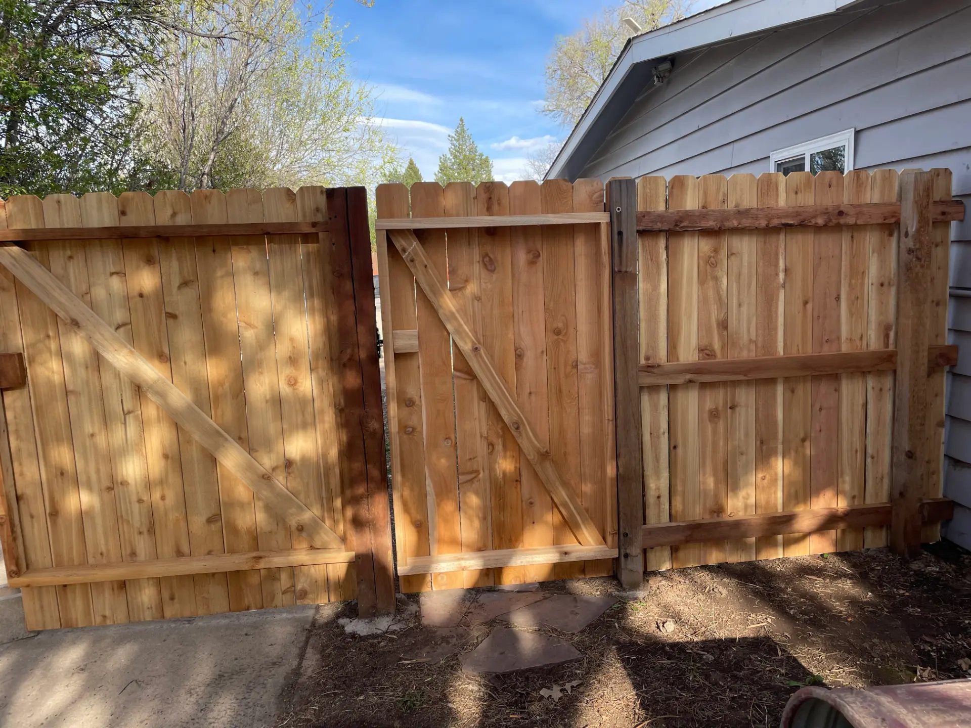 Pair of sturdy cedar privacy gates with diagonal wood bracing